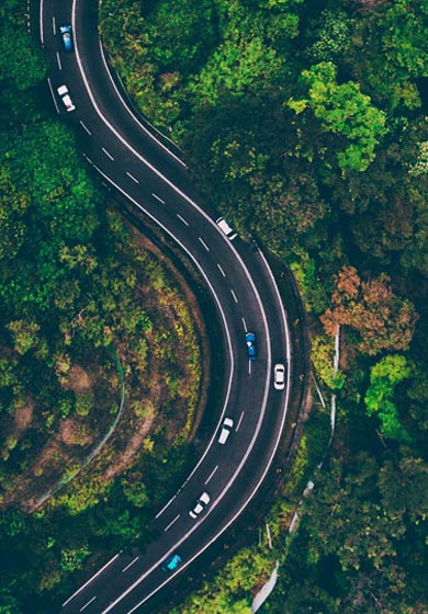 Drone flying over forest highway
